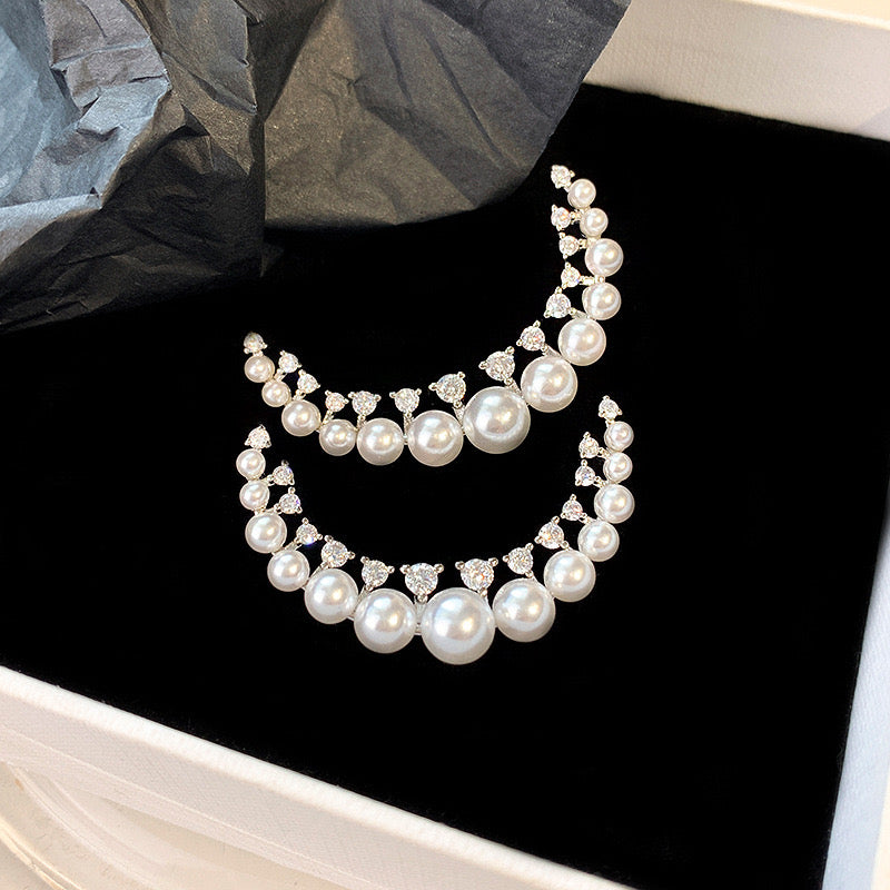 Pearl and zirconia half moon shaped earrings