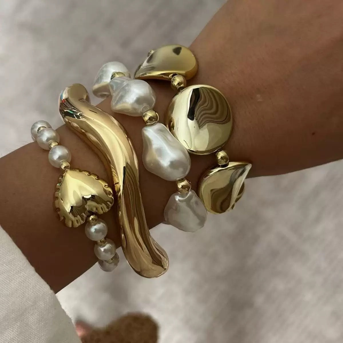 Gold and pearl stack bracelets