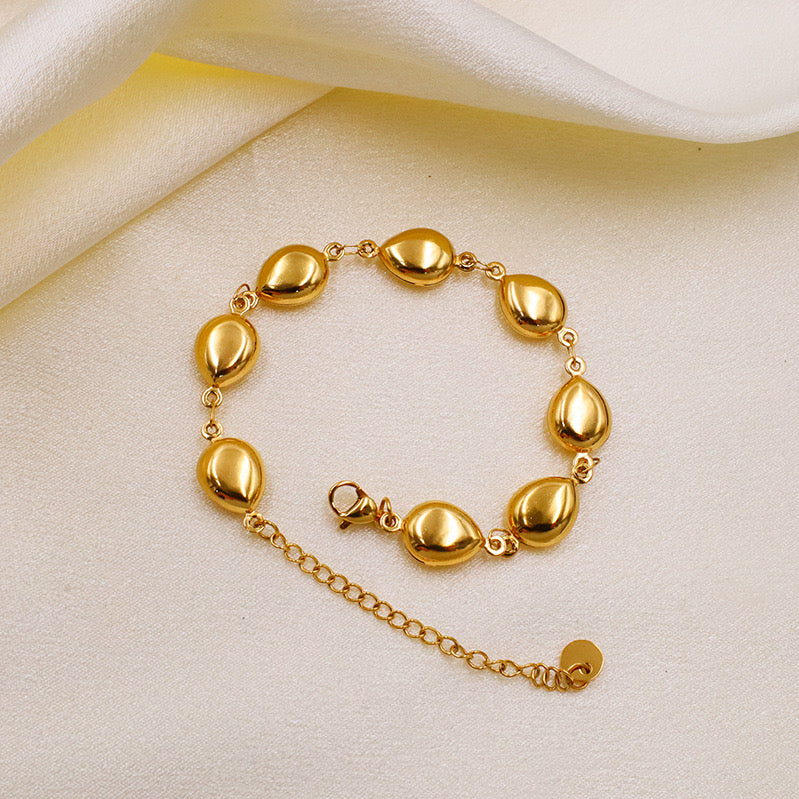 Peb shaped gold necklace and bracelet