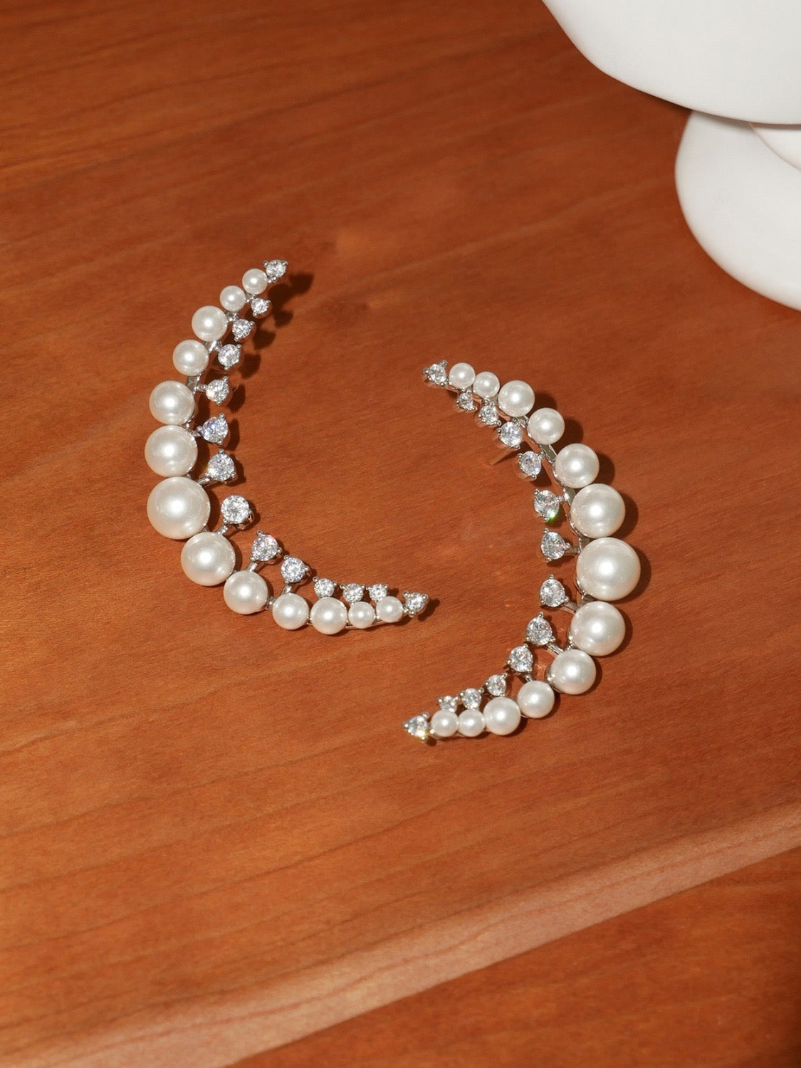 Pearl and zirconia half moon shaped earrings